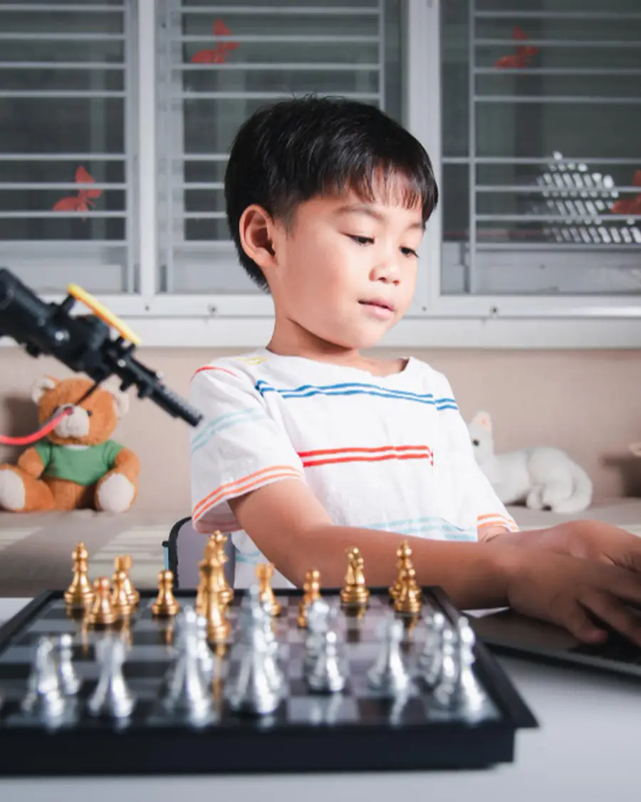 A child working with a robotic arm during a STEAM class at MosKiddo