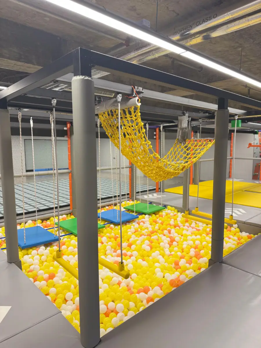 A ball pit with ropes and monkey bars in the open play area at MosKiddo