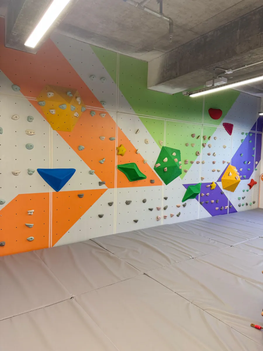 A bouldering wall in the open play area at MosKiddo
